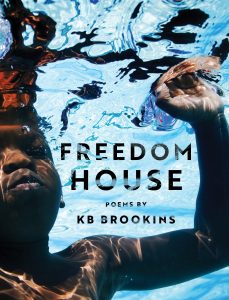Cover image of KB's poetry collection "Freedom House," which features a young boy with dark skin underwater with rays of sunlight shining from above.