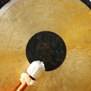 gong and mallet surrounded by South Asian spices