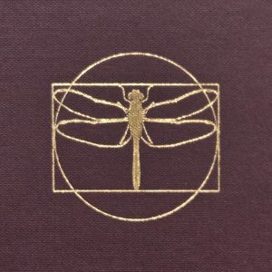 Image of a dragonfly within a circle and rectangle. The icon is gold and the background is the textured burgundy of book cloth.