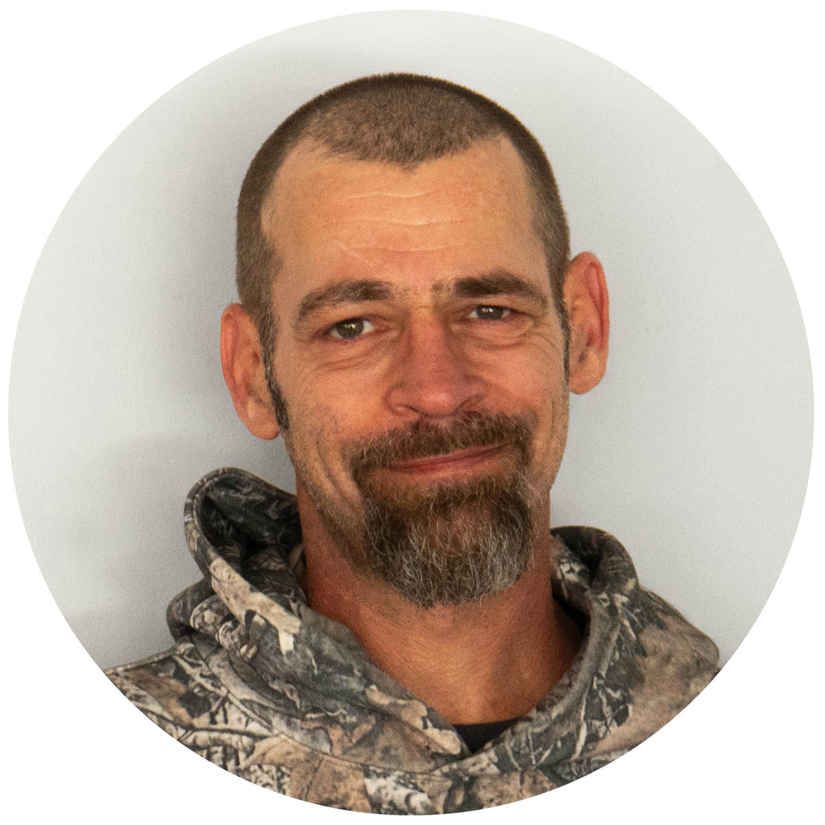 Headshot of a light-skinned man with short hair and a beard