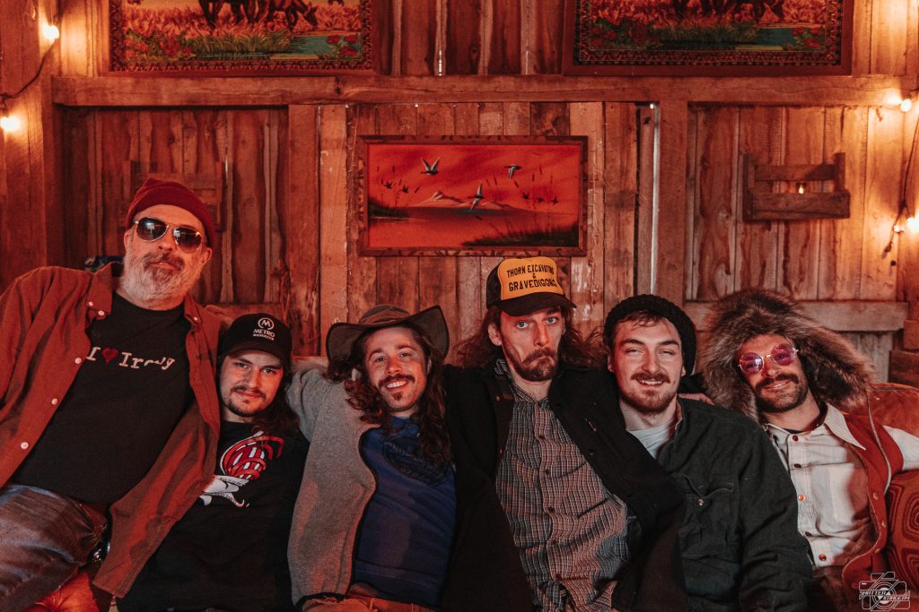 Saltydog band against a wooden background