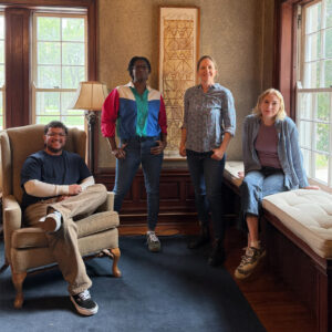 Four artists pose in the Historic Residence
