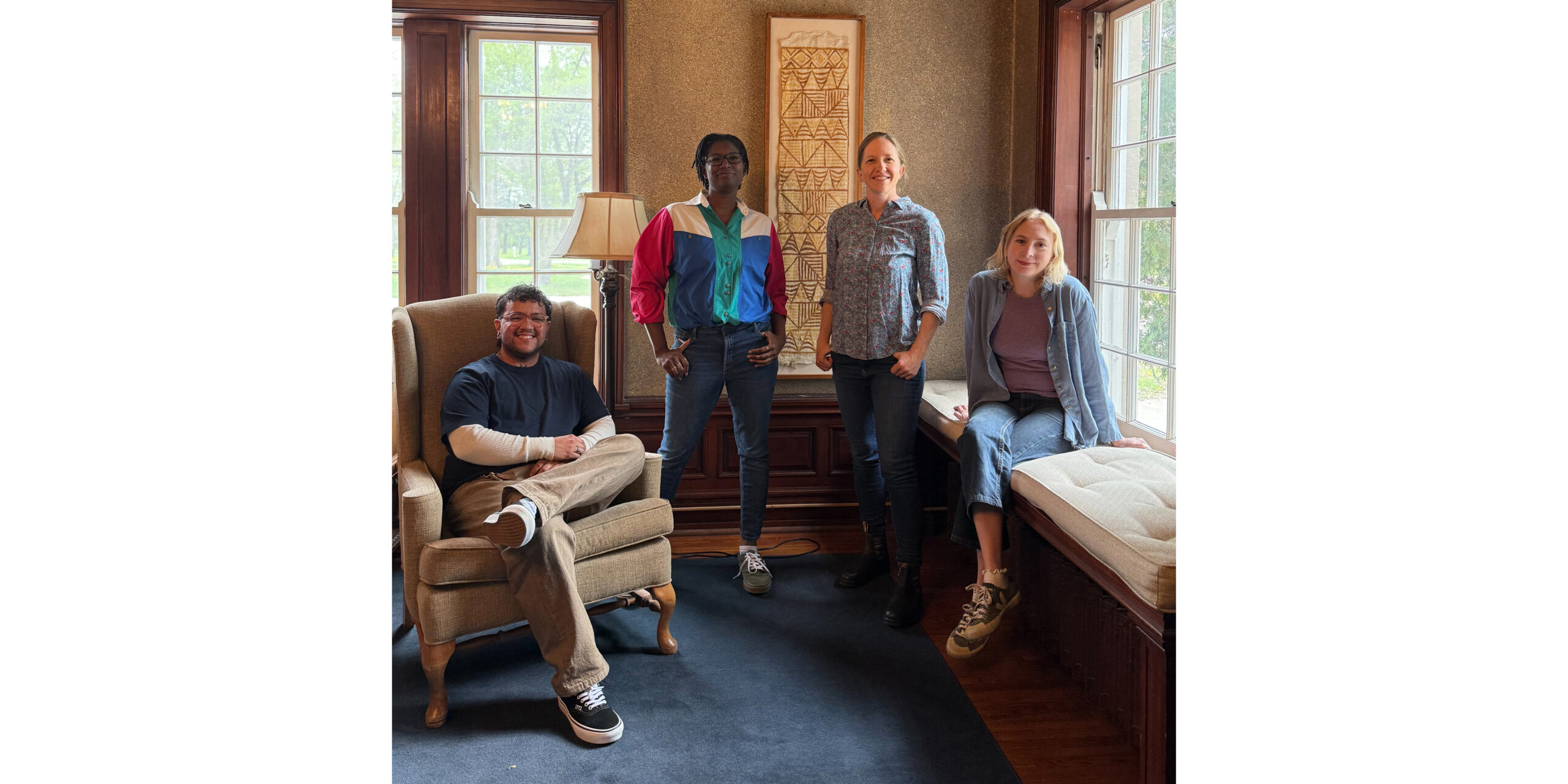 Four artists pose in the Historic Residence