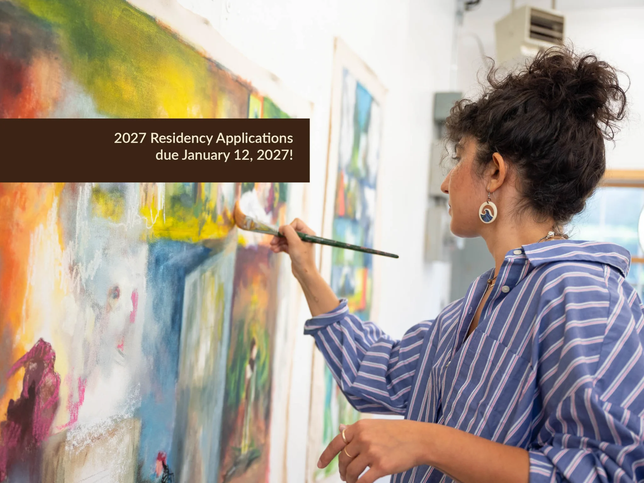 Red Wing Area Studio Tour 2025 logo in front of a smiling woman in her studio